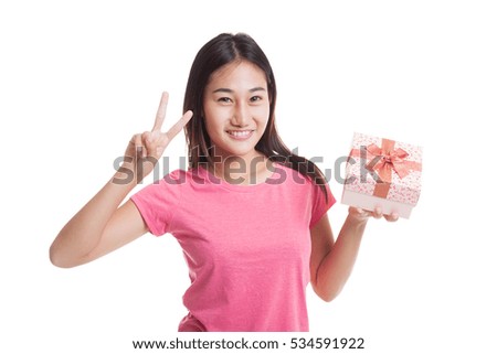 Young Asian woman show Victory sign with a gift box isolated on white background.