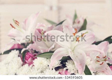 Bouquet of flowers on light wooden background