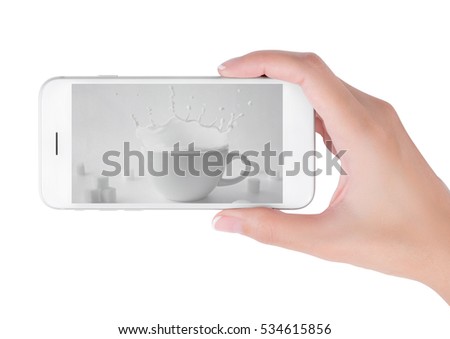 Woman using her smart phone searching milk splash with cube sugar in still life photography, Food and drink concept, isolated on white background.