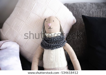 photo of Rabbit doll toy laying on the bed with pillows