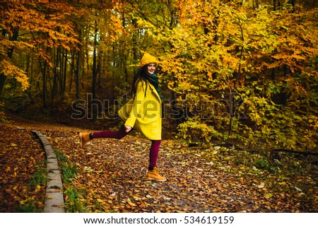 beautiful young woman walking outdoors in autumn