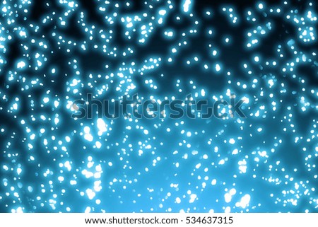 Christmas round blue bokeh or glitter lights on dark background.Abstract circle defocused particles