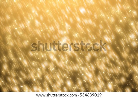 Golden sparkles or glitter lights. Merry Christmas festive background.defocused circle particles