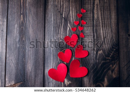 Red paper heart  on the old wood table background. Valentine's day concept