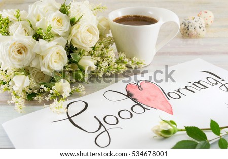 white roses, coffee and good morning note on a table