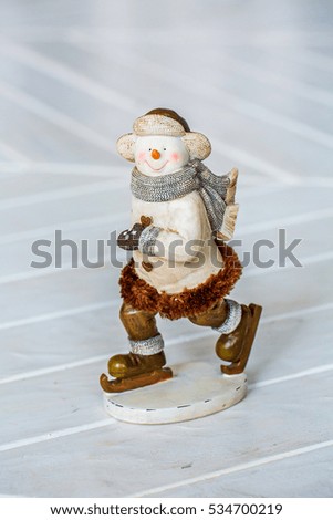 figurine snowman, skating, closeup