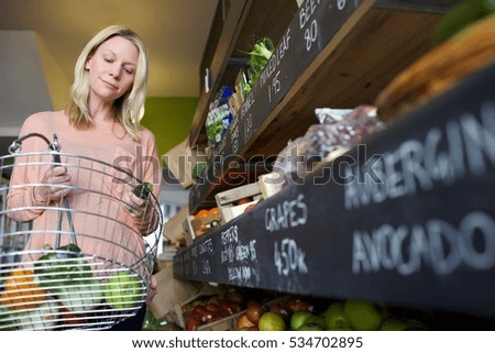 Woman buying produce in store