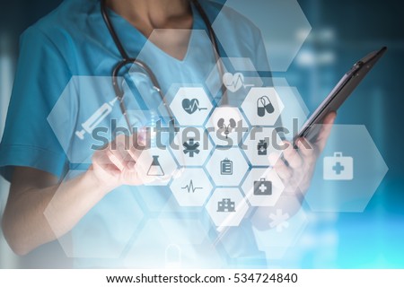 young woman nurse or doctor is using innovative technologies in order to manage her work in the hospital
