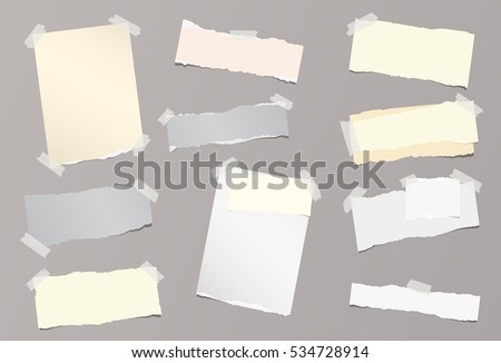 Pieces of different size ripped note, notebook, copybook sheets stuck with sticky tape on background. Royalty-Free Stock Photo #534728914