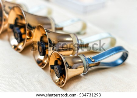 Golden handbells ready to play close up Royalty-Free Stock Photo #534731293