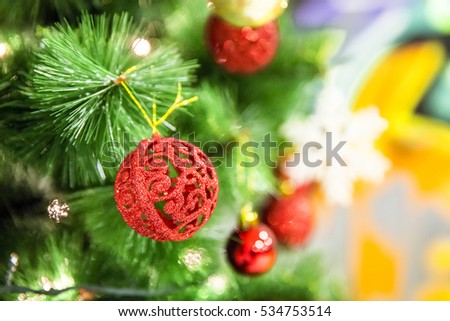 Christmas ball ornaments decoration hanging on fir tree over red circle bokeh blurred night light background with copy space for text, greeting card happy new year 2017 selective focus