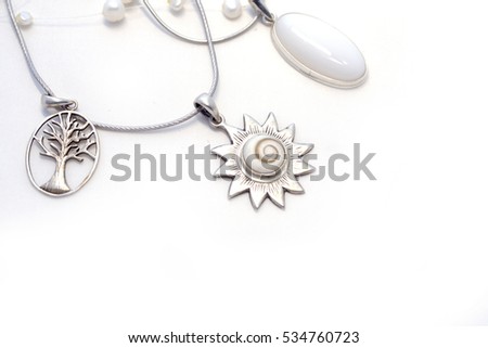 Sterling Silver jewelry on a white background, pearls