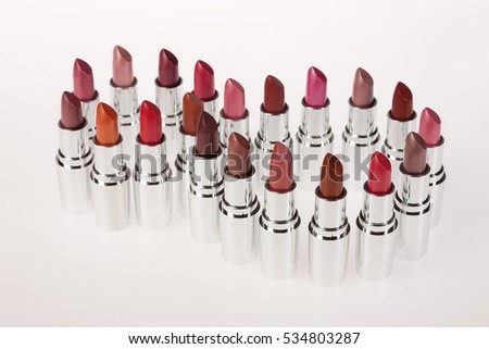Tubes with different kinds of lipstick on studio background