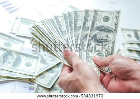 Man counting money, man in business clothes with dollars, Cash in hands. Profits, savings. Stack of dollars. Success, motivation, financial flows, wealth. Stack of dollars,dollars in hand. Rich people Royalty-Free Stock Photo #534831970