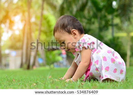 Portrait of adorable funny baby girl in the garden