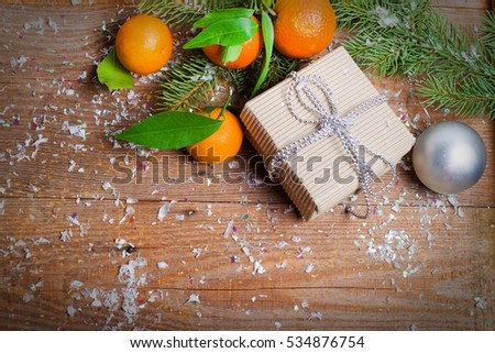 Composition with Tangerines Green Leaves, snow  Wooden  Background