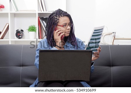 woman with laptop computer and mobile the document, paper or bill