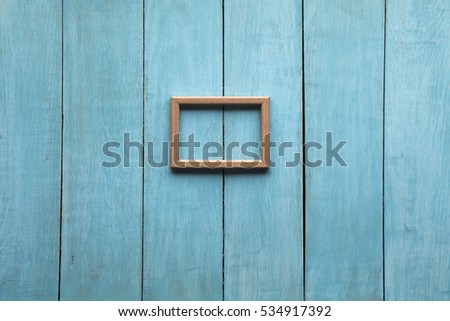 old wooden photo frame on blue wooden wall