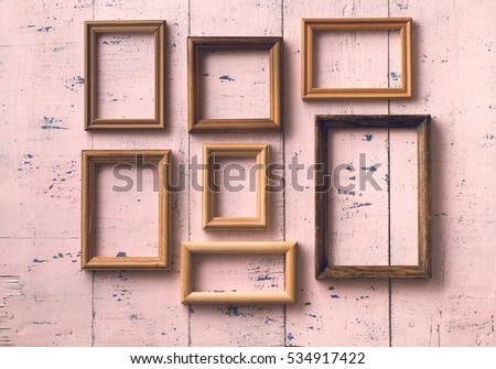 vintage photo frames on old pink wooden wall