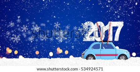 Blue retro toy car delivering Christmas or New Year 2017 on festive blue background