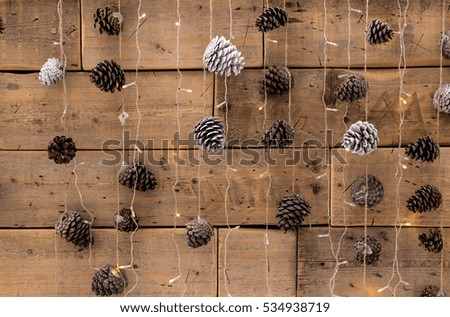 garland of real pine cones. vintage style wooden texture background. Happy New Year. Empty space for your text.