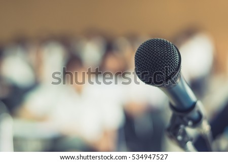 Microphone voice speaker with audiences or students in seminar classroom, lecture hall or conference meeting in educational business event for host, teacher, or coaching mentor  Royalty-Free Stock Photo #534947527