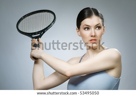 Beautiful sporty girl playing tennis very passionately