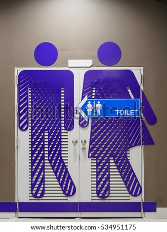 big purple toilet sign and symbol and small blue  toilet sign and symbol on white door at big shopping mall