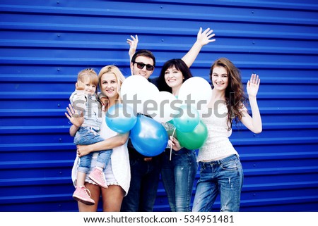 sale, family, generation and people concept - group of happy men and women, happy family with balloons over blue background