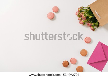 Sweet macaroons being scattered on the table