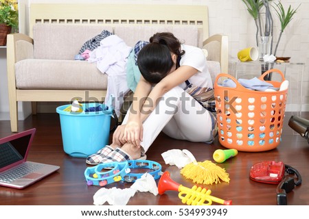 Tired Asian housewife Royalty-Free Stock Photo #534993949