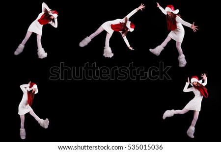 Young woman gymnast dressed as santa's elf jumping in the air without visible ropes isolated on black background