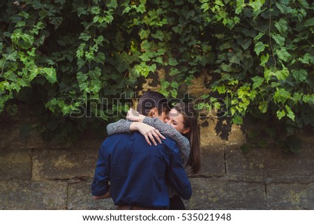 Man and woman walking in the city. Man and woman kissing in a city. Close-up.