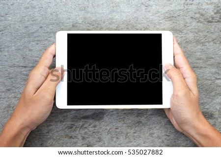 hand using tablet on top view. Clipping path included.