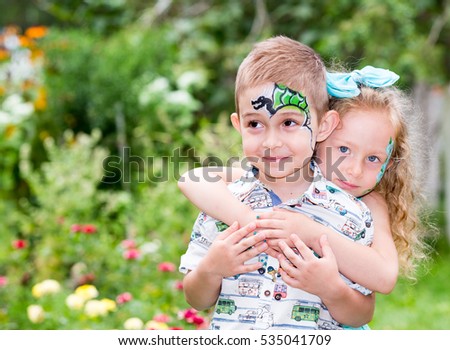 The boy and girl child with aqua make-up on happy birthday. Celebration concept and childhood, love