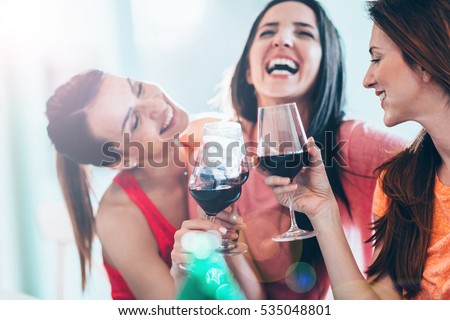 Friends drinking wine in restaurant Royalty-Free Stock Photo #535048801