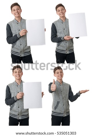 Cute teenager boy in gray sweater holding paper bill board over white isolated background, half body