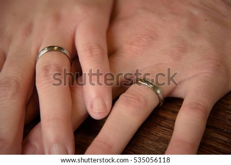 Hands of just married couple with wedding rings