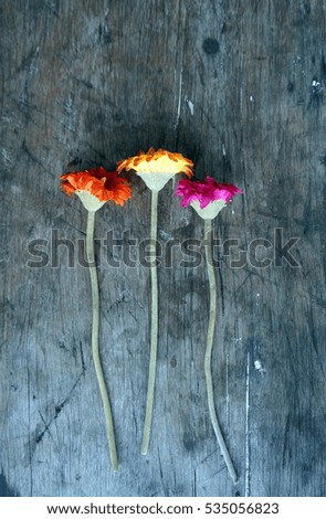 three sun flower on a rustic wooden table
