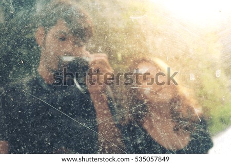 Blur image of boyfriend and girlfriend was photographed on old mirror 
