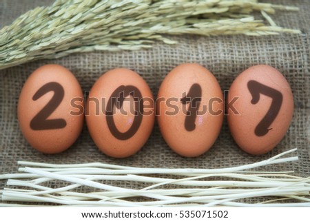 Four eggs laid on a cloth sack numbers in 2017 with color filters/vintage style.