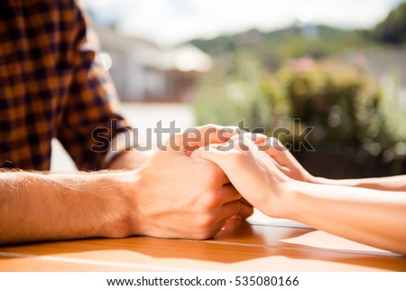 Close up of romantic couple in love holding each other hands Royalty-Free Stock Photo #535080166