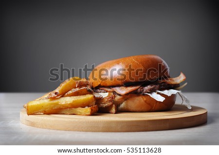 Homemade hamburger with fries and with dark background