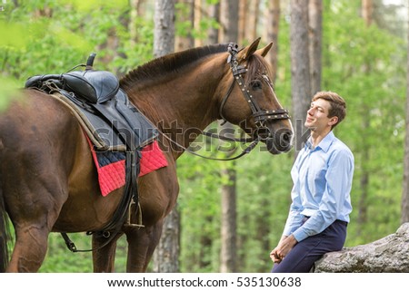 Handsome young man with a horse.