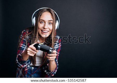Cheeful involved girl playing video games