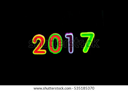 Burning candles on black background, number 2017, new year concept