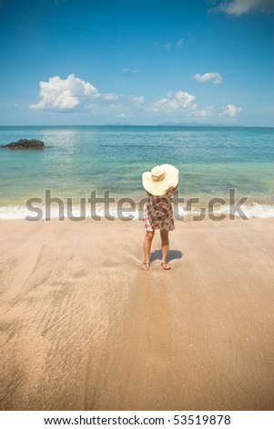 girl standing alone on the beach.