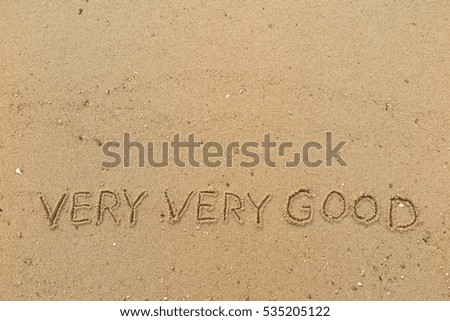 Handwriting words "VERY VERY GOOD" on sand of beach
