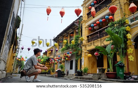 a man  looking the old building at street of Hoi An, Vietnam
 Royalty-Free Stock Photo #535208116
