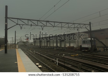 The railway with the dark cloudy sky